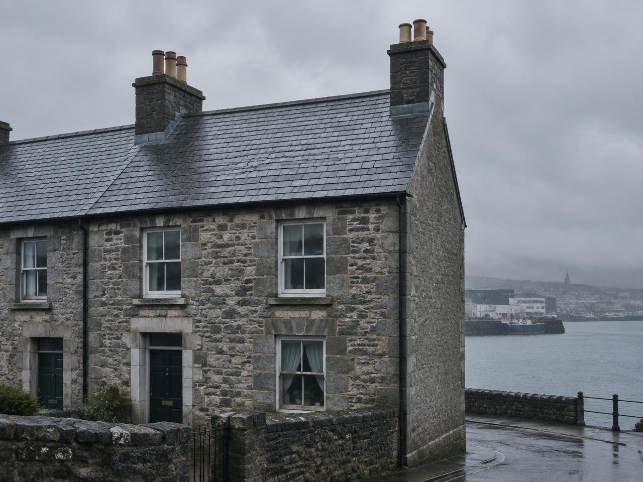 Weathered slate roof on a Galway terrace under a heavy grey Atlantic sky